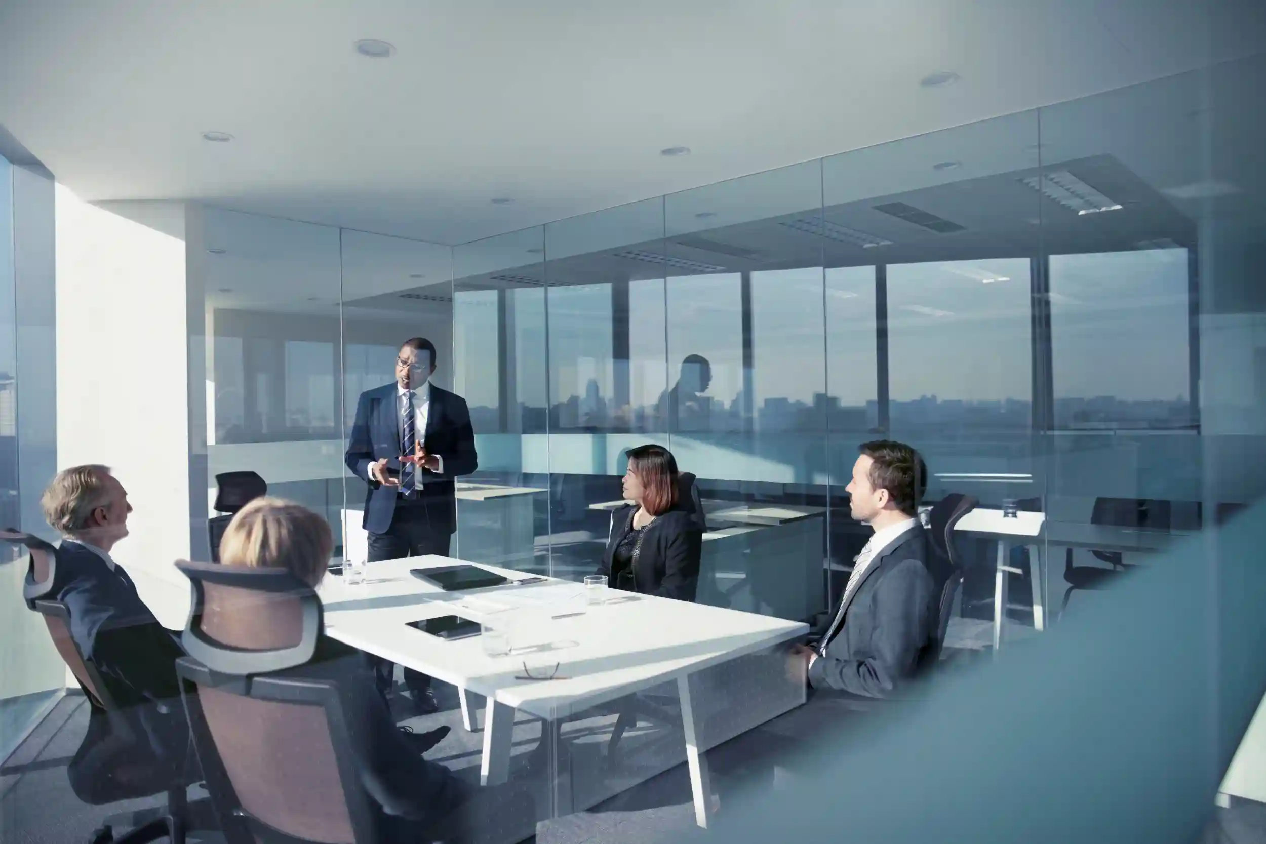 Man presenting in front of coworkers.